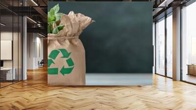 Two brown fabric bags with green recycling symbols. Eco-friendly recycling concept on wooden surface. Sustainability and environmental conservation. Blurred blackboard background. Space for text Wall mural