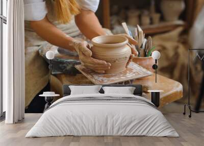 hands of a potter, creating an earthen jar on the circle Wall mural