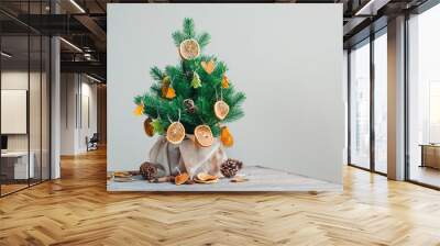 Dried citrus carved slices on the Christmas tree as natural decorations Wall mural