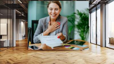 Happy business woman receiving a certificate in office Wall mural