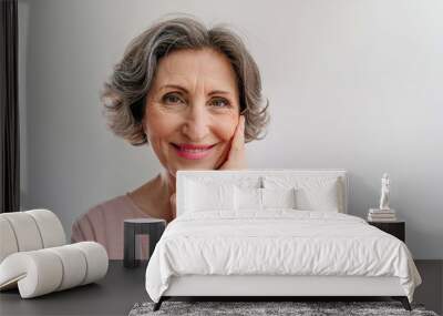 Happy stylish mature woman on light grey background Wall mural