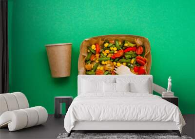 Steamed vegetables in the brown kraft paper food containers on green background Wall mural