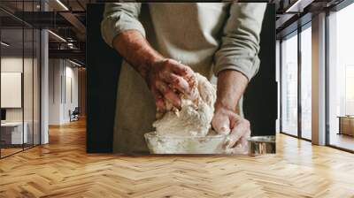 Unrecognizable man in an apron kneading the dough Wall mural