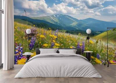 A vibrant meadow of wildflowers in bloom with mountains in the background and a partly cloudy sky. Perfect nature, landscape, and travel imagery. Wall mural