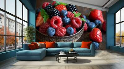 Fresh berries in a bowl with mint leaves, perfect for a healthy snack or dessert. Wall mural