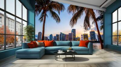 Miami, Florida skyline and bay at sunset seen through palm trees  Wall mural