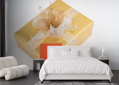 Blank adhesive note on gold gift box on white background Wall mural