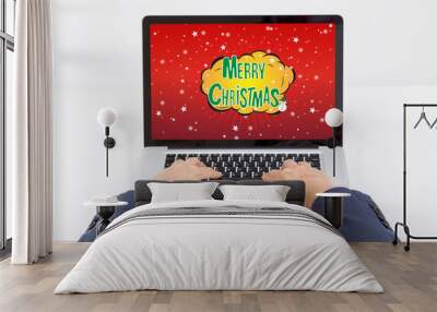 Businessman hands typing laptop computer with merry christmas on Wall mural