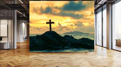 Cross on the rock in the ocean at sunset background Wall mural