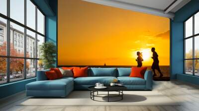 Silhouette of people  jogging at the beach with sunset backgroun Wall mural