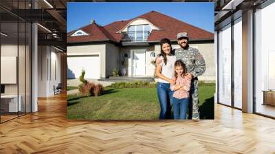 Portrait of happy american military family in front of their house. Wall mural