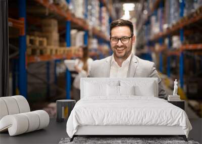 Portrait of successful middle aged caucasian manager businessman holding tablet computer in large warehouse organizing distribution. Business people. Wall mural