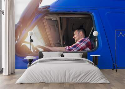 Truck driver occupation. Caucasian middle aged trucker driving long vehicle. Transportation services. Wall mural