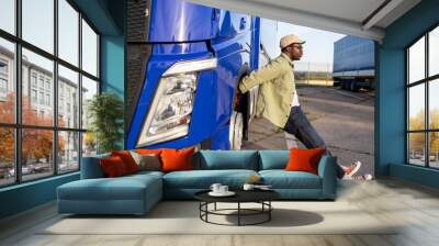 Truck driver stretching his body and muscles after a long ride. Wall mural