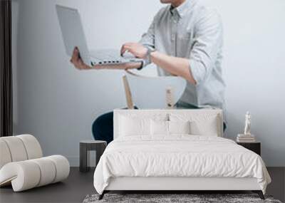 Young men in gray shirts work with laptop computers Wall mural