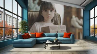 The Little Girl Holding a Gift Box - a delightful and cheerful visual. The girl’s expression of excitement brings joy to the scene. Wall mural