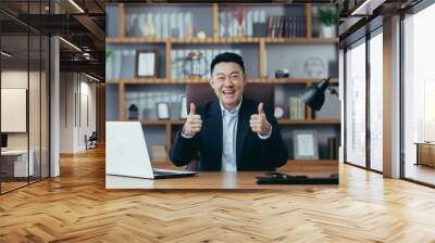  Asian man diplomat, director, businessman looking at the camera smiling, concluding a contract, holding a meeting, video call conference, consults. Explains, sits at a table in the office at work Wall mural