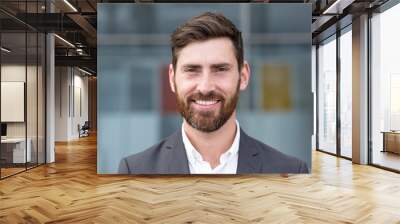 Boss man looking at camera and smiling, young businessman banker with beard photo with close up portrait Wall mural