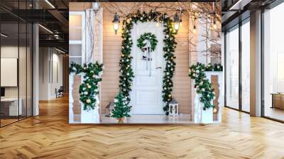 Decor on the front door of the house close-up, New Year and Christmas decorations on the facade, white front door, winter day. Wall mural