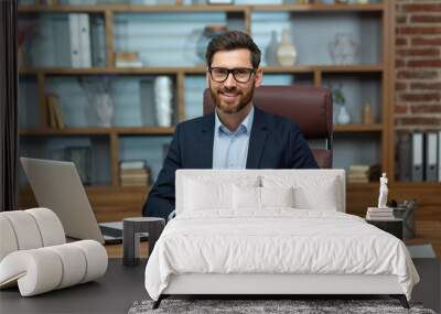 Portrait of successful and happy mature financier, senior businessman with beard and glasses smiling and looking at camera, man working inside office on paper work, investor satisfied with result. Wall mural