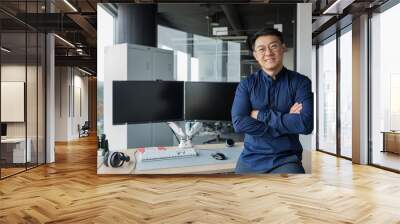 Portrait of successful programmer in modern office of development company, asian man with crossed arms smiling and looking at camera. Wall mural