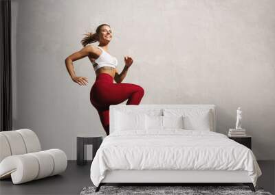 fit woman exercising outdoors. healthy young female athlete doing fitness workout. sportswoman raisi Wall mural