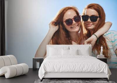 Two red head twins wearing shades. Sister girls wearing black glasses on a sunny summer day, looking at camera smiling. Having a close supporting friend is luck. Wall mural