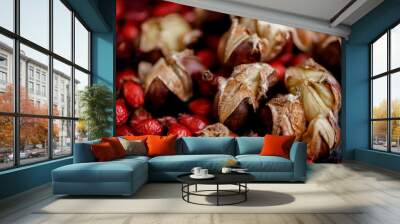 Top view of chestnuts and red dry rose hips. Roasted delicious fresh chestnuts. Shallow depth of field. Toned image. Wall mural