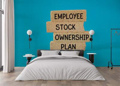 Concept words ESOP - Employee Stock Ownership Plan on brick blocks. Beautiful blue background. Business concept. Wall mural