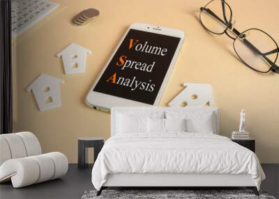 Concept words VSA, Volume Spread Analysis on the mobile phone screen. Beautiful beige background. Glasses, miniature houses, coins. Business concept. Wall mural