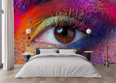 Close up view of female eye with bright multicolored fashion makeup. Holi indian color festival inspired. Studio macro shot Wall mural