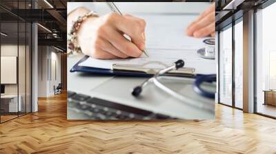 Close up view of female medicine doctors hands filling patient m Wall mural