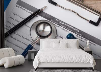 Stethoscope and pen laying on patient information blank Wall mural