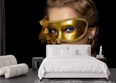 Young beautiful woman wearing golden party mask Wall mural