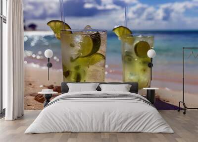 Mojitos on the beach. Fresh cold cocktail on tropical beach. Tropic summer vacation. Exotic drinks on blur tropical beach background Wall mural