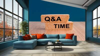 Q and A, questions and answers time symbol. Concept words 'Q and A time' on brick blocks on a wooden table, beautiful blue background. Business and Q and A time concept. Wall mural