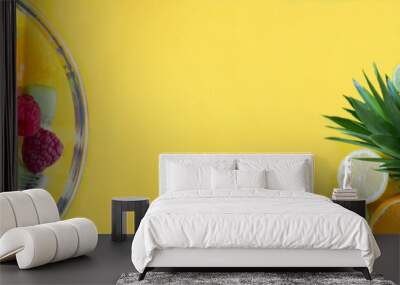 Banner. Tropical fruits and fruit salad in the glass bowl on the yellow background. Closeup. Copy space. Wall mural