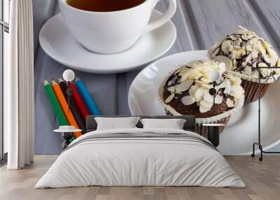 Chocolate muffins, tea and pencils on the grey wooden background Wall mural