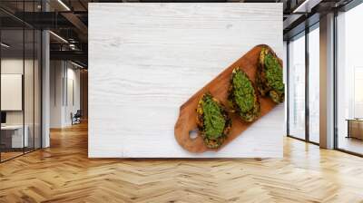 Grilled chimichurri chicken breast on a rustic wooden board on a white wooden table, top view. Copy space. Wall mural