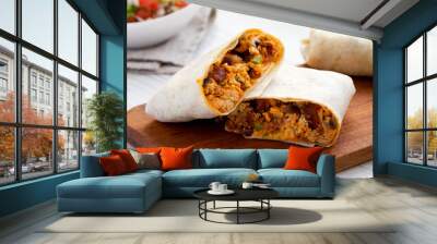 Homemade chorizo breakfast burritos on a rustic wooden board on a white wooden table, side view. Close-up. Wall mural