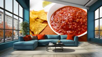 Homemade Tomato Salsa and Nachos on a rustic wooden board, low angle view. Close-up. Wall mural