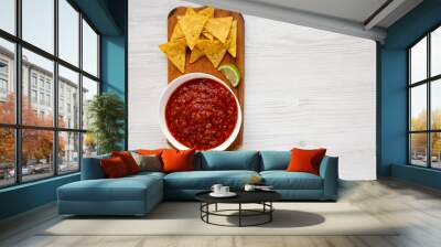 Homemade Tomato Salsa and Nachos on a rustic wooden board on a white wooden background, top view. Flat lay, overhead, from above. Space for text. Wall mural