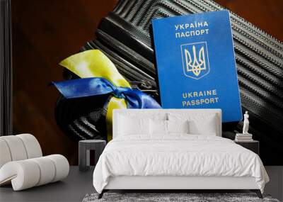 Ukrainian passport ID on luggage, yellow-blue flag ribbons. Emigration, immigration, refugee, evacuation of civilians, families from Ukraine crossing border. Stop war, support, care concept Wall mural