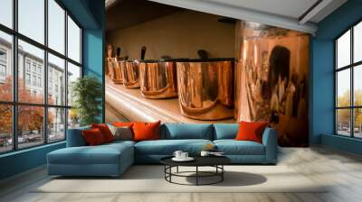 Copper pans on a kitchen shelf Wall mural