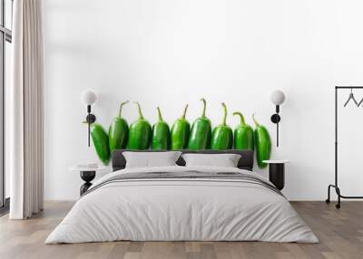 A row of bright green jalapeno peppers isolated on a white background with copy space Wall mural