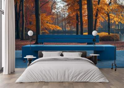 A blue park bench amidst autumn foliage Wall mural