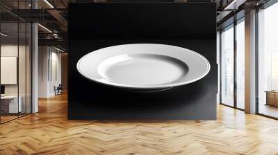 A white empty plate on a black background Wall mural