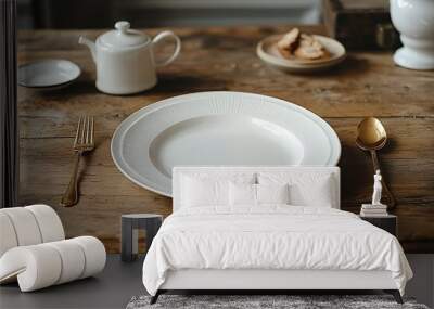 Empty white plate with golden cutlery on a wooden table Wall mural