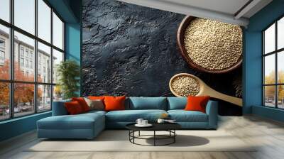 Quinoa grains in a bowl and a spoon on a black background Wall mural