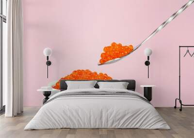 Red caviar in silver spoon isolated on the white background Wall mural